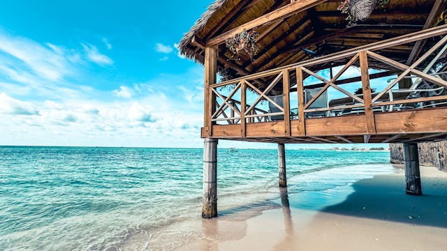 A gazebo hanging over the water of seven mile beach in Grand Cayman