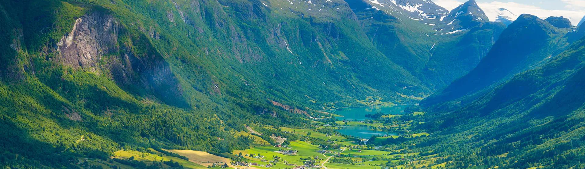 Norway. Cruise ship in the Norwegian fjord. High mountains and reflections on the surface of the water. Clouds over the rocks. Vacation and travel in summer Norway.