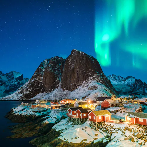 The Northern Lights over a town in the Norwegian Fjords