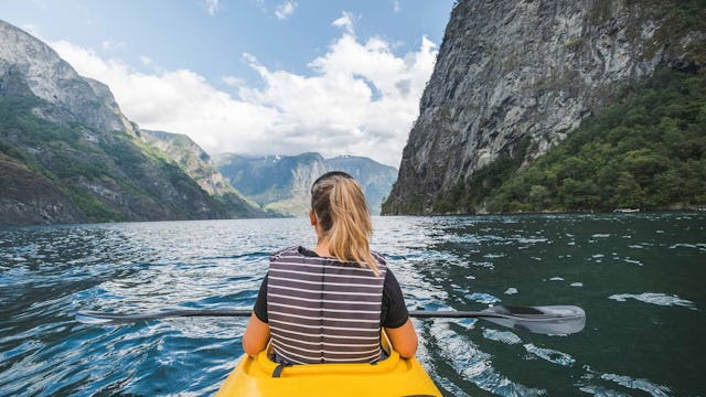 Woman kayaking in Gudvangen in Norway.