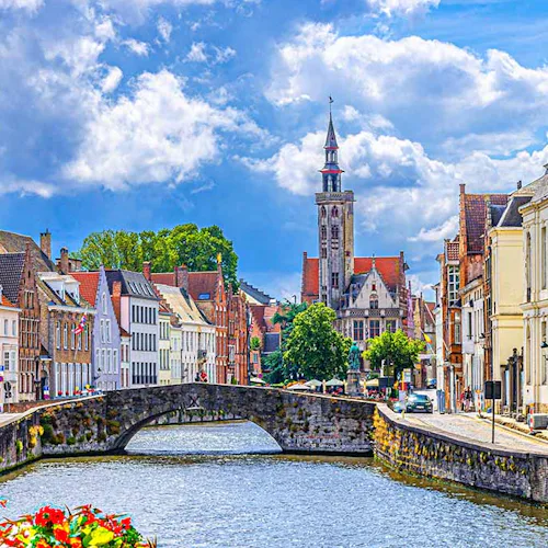 Bruges cityscape, Spiegelrei water canal, Poortersloge tower, King's Bridge and medieval buildings on embankment, Brugge old town quarter