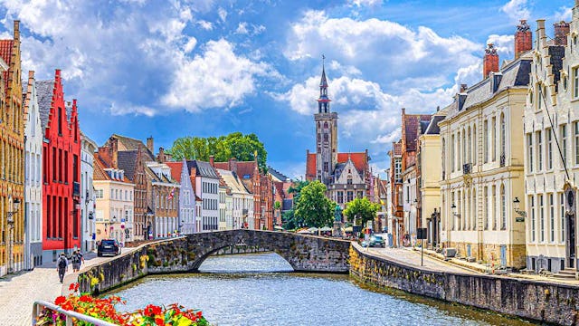 Bruges cityscape, Spiegelrei water canal, Poortersloge tower, King's Bridge and medieval buildings on embankment, Brugge old town quarter