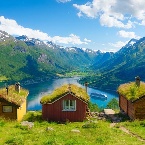 Nature in fjords. Rakssetra, Norway. Panoramic view. Traveling on a Norwegian fjord. Scandinavia. Traditional old settlement. Houses with moss on the roof.