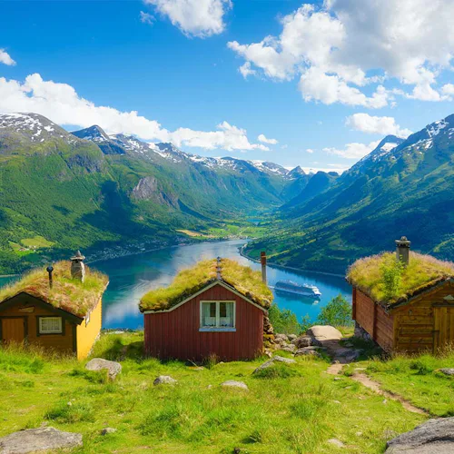 Nature in fjords. Rakssetra, Norway. Panoramic view. Traveling on a Norwegian fjord. Scandinavia. Traditional old settlement. Houses with moss on the roof.
