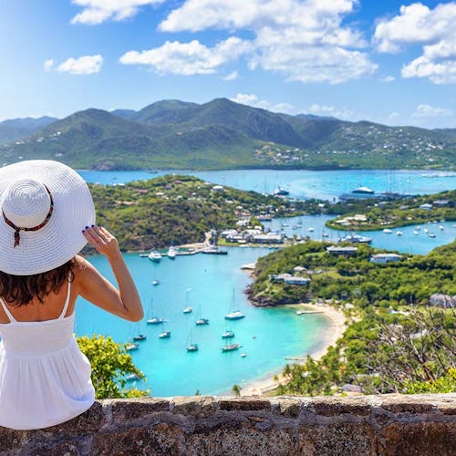 Woman wearing white overlooking Antigua in the Caribbean