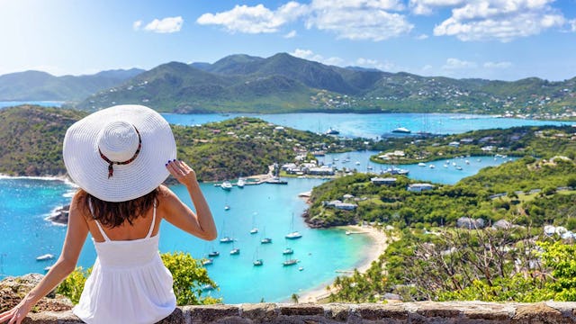 Woman wearing white overlooking Antigua in the Caribbean