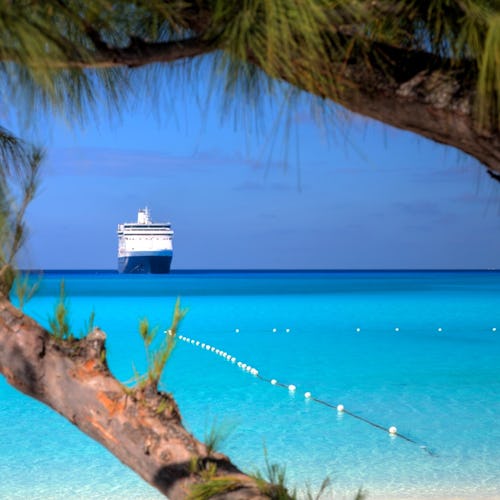 A ship waits on the horizon on a beautiful beach in the Caribbean