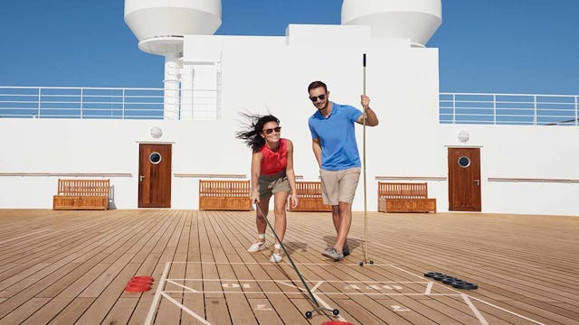 Passengers playing shuffleboard on board Cunard ship