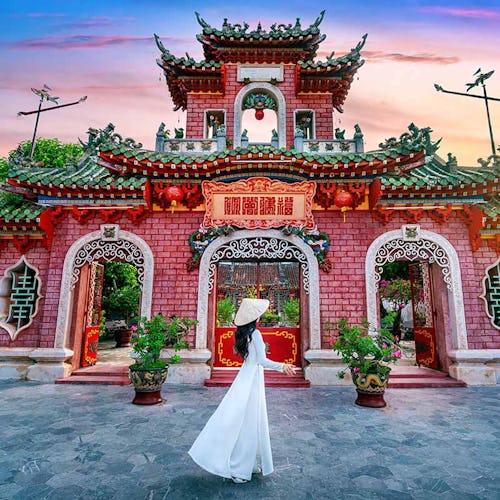 Tourist walking at Fukian Assembly Hall in the Hoi An ancient town, Vietnam.