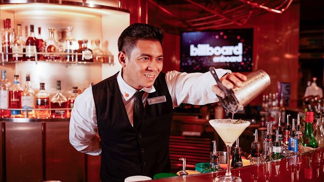 Bartender serving drinks on board Holland America ship