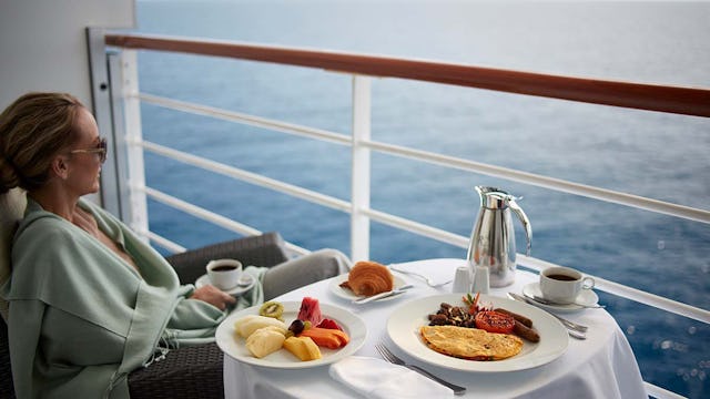 Oceania Cruises Passenger enjoying breakfast on the balcony