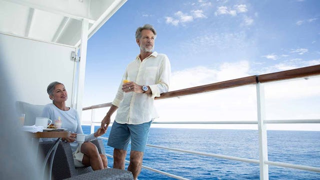 Couple on a balcony of Seven Seas Voyager
