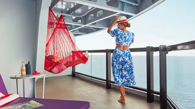 Virgin Voyages passengers hanging out on a balcony
