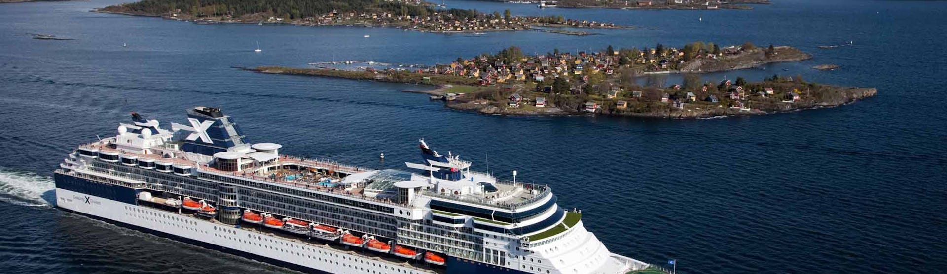 Celebrity Constellation Cruise Ship sailing past an island