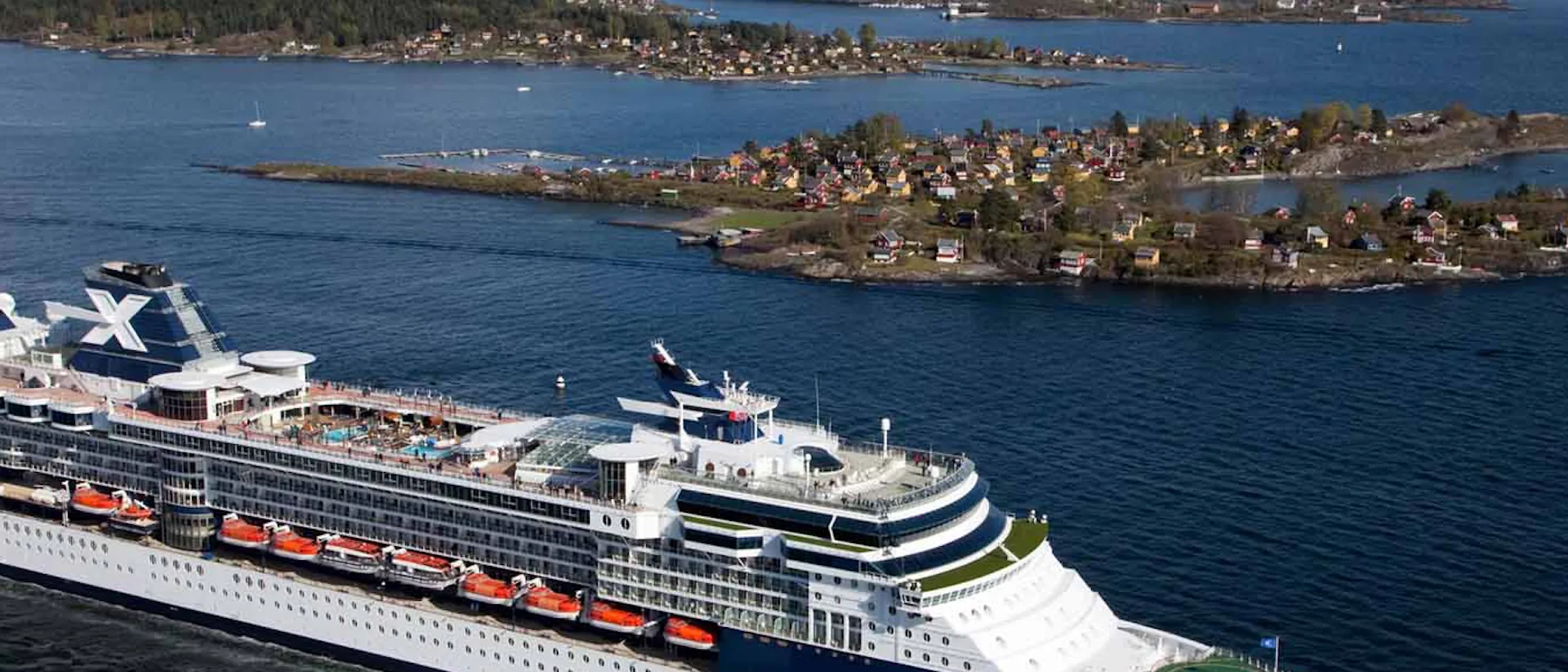 Celebrity Constellation Cruise Ship sailing past an island