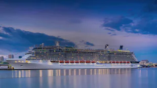 Celebrity Reflection cruise ship docked at dusk