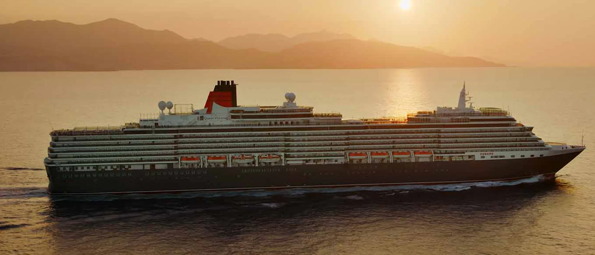 Cunard Queen Victoria sailing at sunset