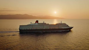 Cunard Queen Victoria sailing at sunset