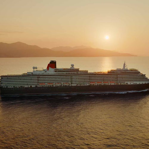 Cunard Queen Victoria sailing at sunset