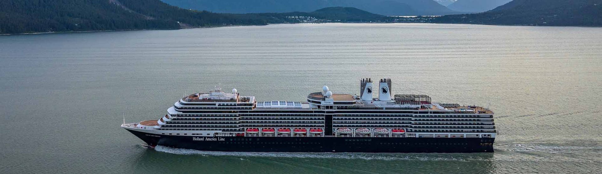 Holland America Nieuw Amsterdam sailing through mountains