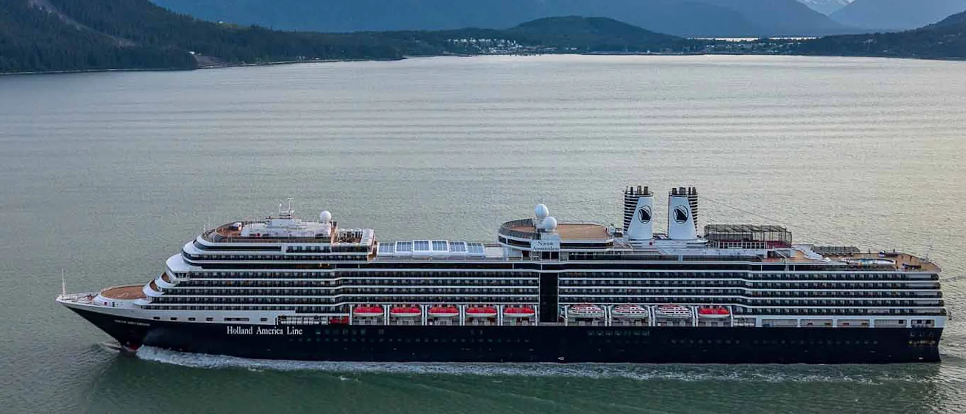 Holland America Nieuw Amsterdam sailing through mountains