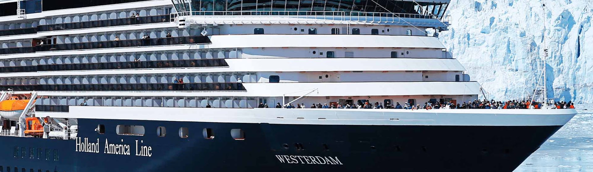 Holland America Westerdam cruise ship sailing through snowy mountains