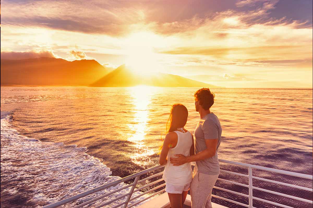 Couple enjoying a sunset on a cruise ship deck